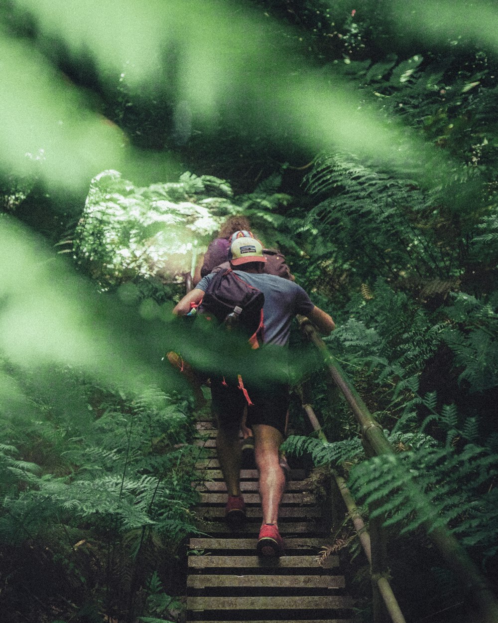 man and woman crossing bridge