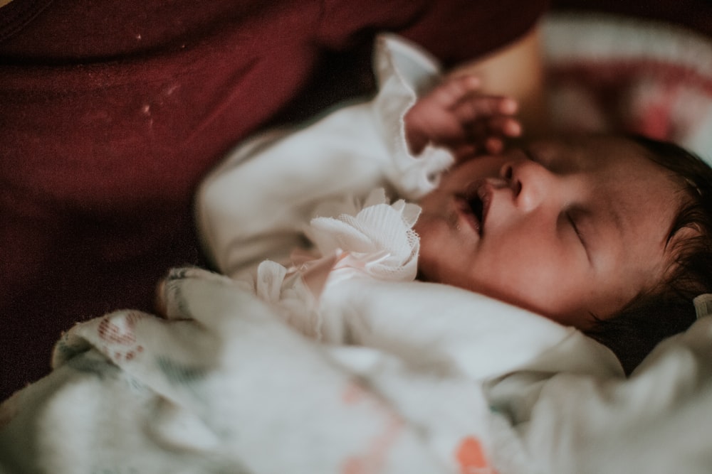 a baby is laying down on a blanket