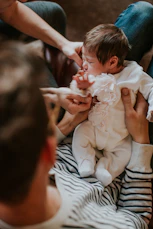 man carrying baby
