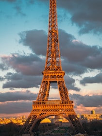 A stunning view of the Eiffel Tower at sunset with a warm golden glow.