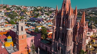 Aerial view of a vibrant town in Caldas with community members engaged in public meetings.