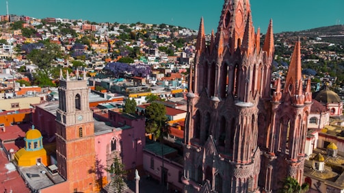 Aerial view of a vibrant town in Caldas with community members engaged in public meetings.