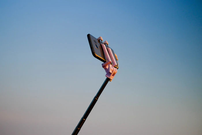 A smartphone mounted on a small monopod