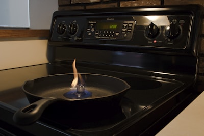 Heavy-duty cast iron skillet glowing warmly on a black slate stove top.