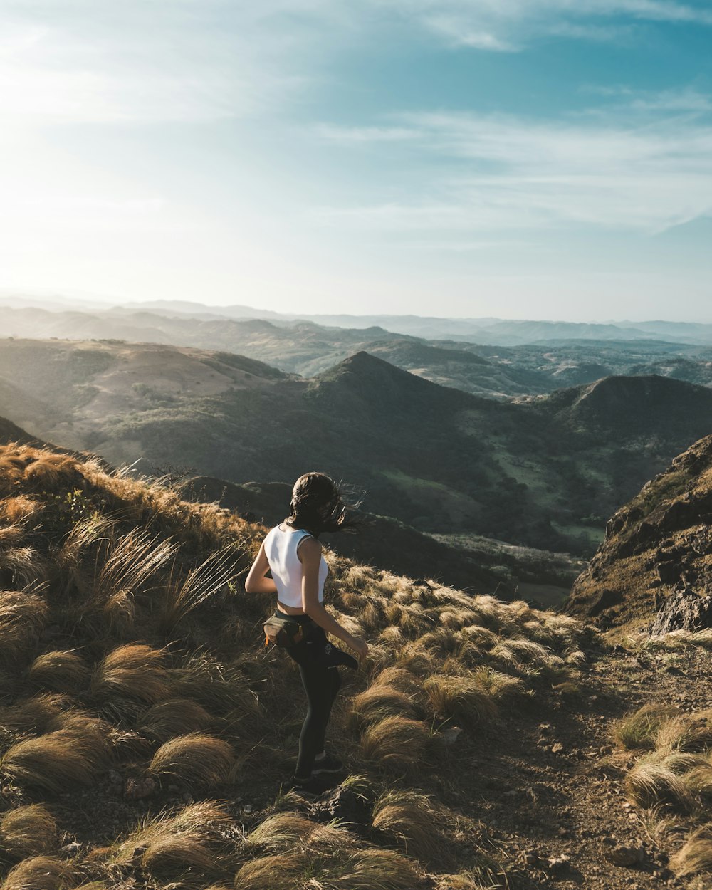 woman walking on brown mountain