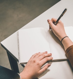 person writing on white paper