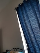 Bedroom featuring blackout curtains in deep blue for restful nights