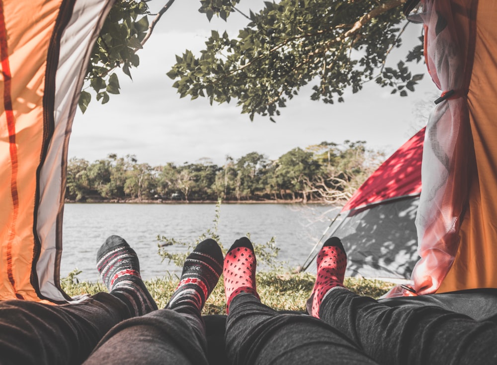 two person laying inside tent