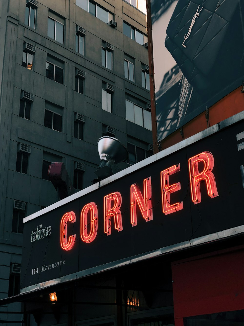 red The Corner neon signage on building turned on