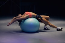 woman doing yoga on stability ball