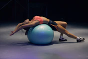 woman doing yoga on stability ball