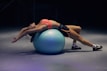 woman doing yoga on stability ball
