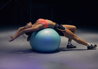 woman doing yoga on stability ball