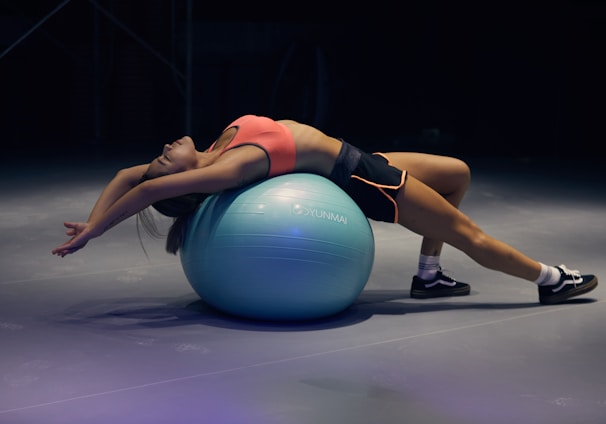 woman doing yoga on stability ball