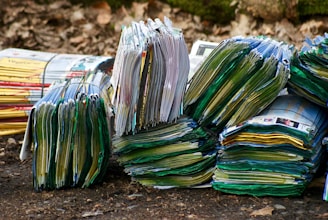 A stack of colorful leaflets fanned out on a wooden table.