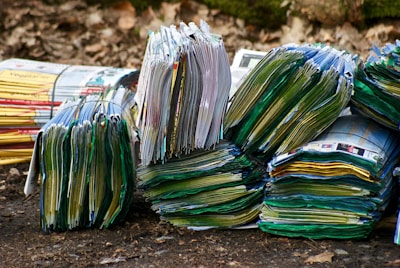 A stack of vibrant flyers spread out on a wooden table ready for distribution.