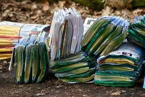 Stacks of vibrant printed flyers and brochures spread out on a table.