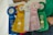 Five prize ribbons in different colors, each labeled with places awarded at the Ocean County Fair Fun Day. The ribbons are blue, yellow, white, pink, and green, representing third to sixth places.