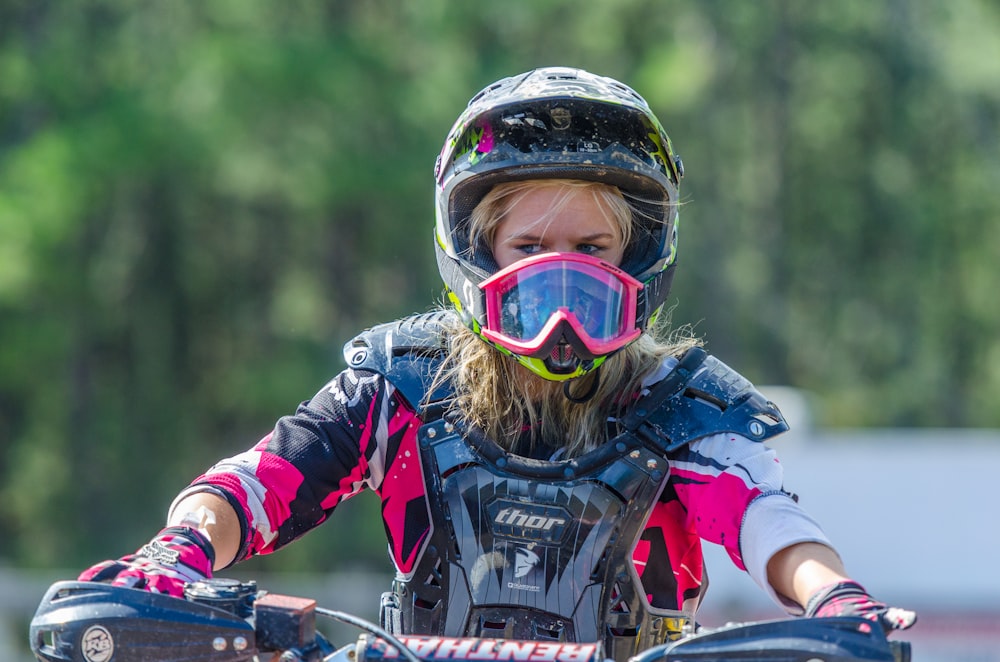 woman riding motocross dirt bike at daytime