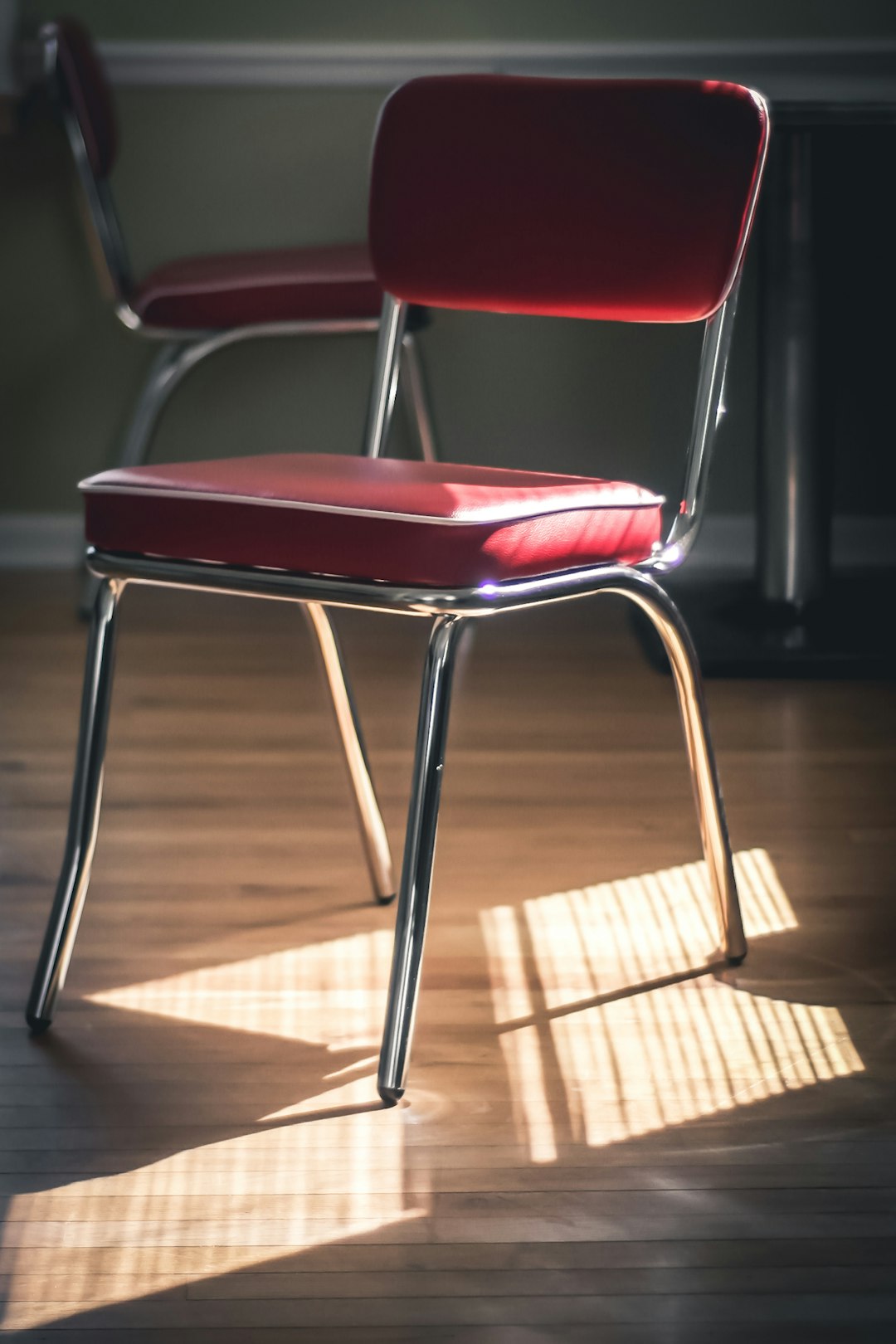 red and silver chair on brown wooden floor