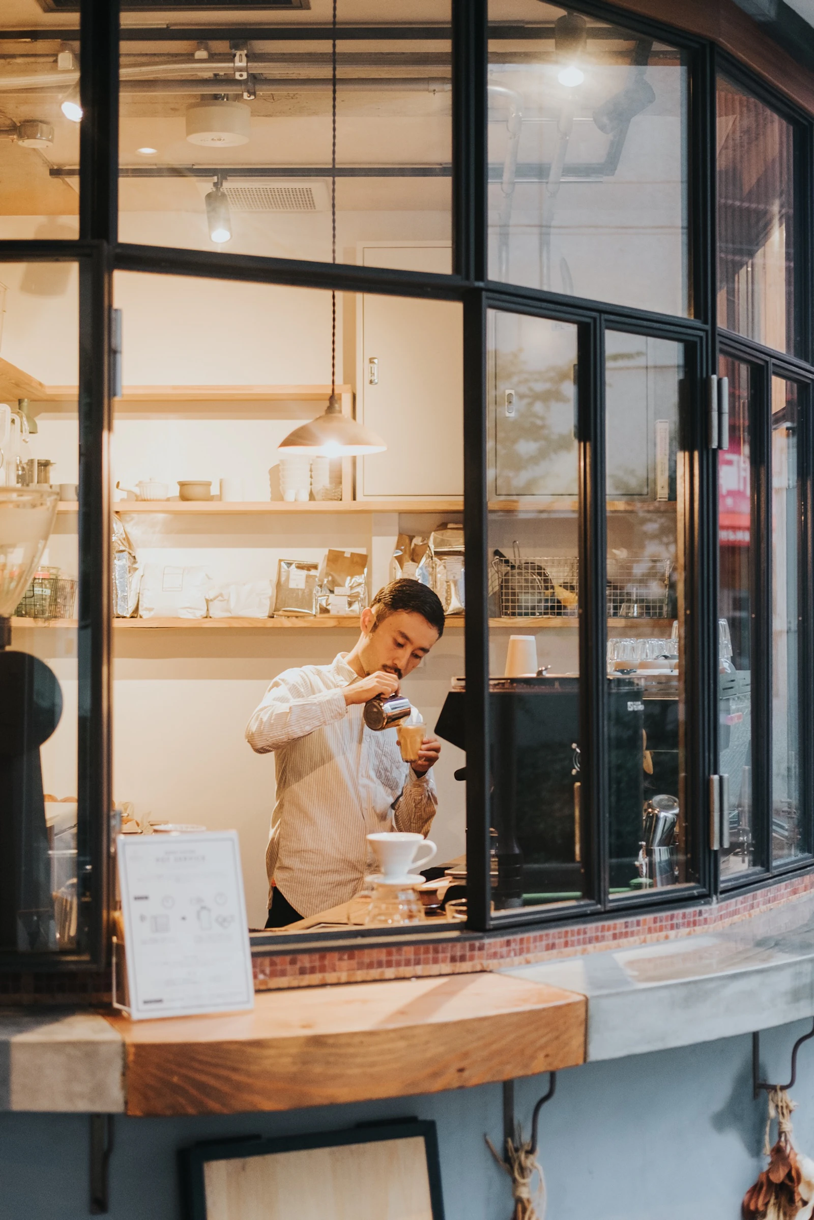 Two friends talking and laughing at a coffee shop