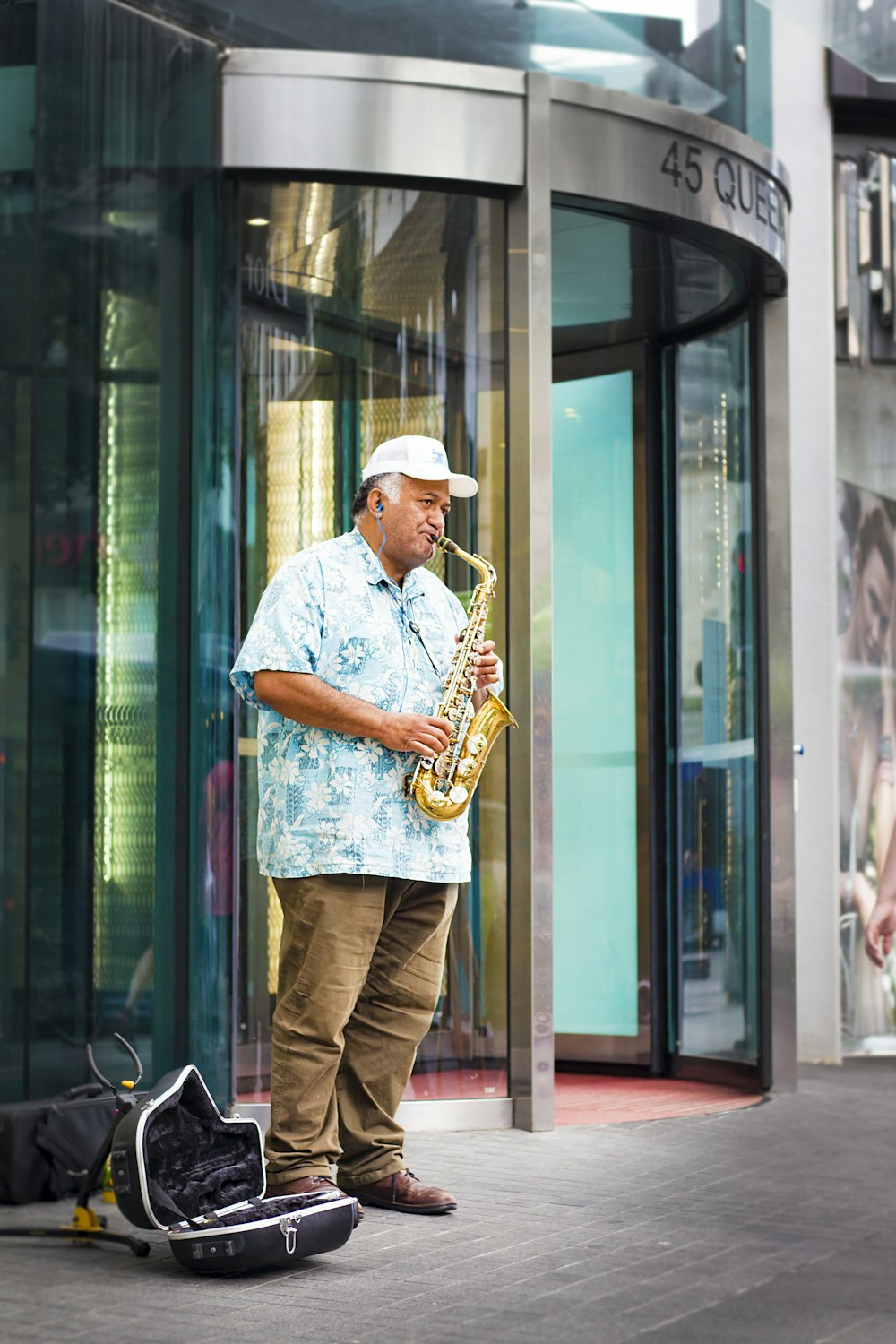 man standing playing saxophone