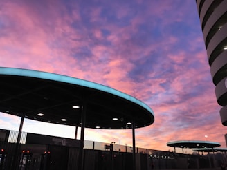 A vibrant photo capturing the entrance of a new society flat complex in Dwarka at sunset.