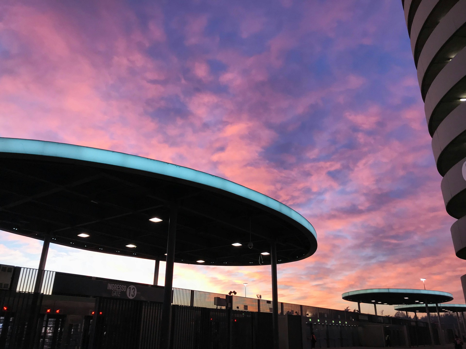 A breathtaking view of a contemporary structure set against a vibrant sunset.