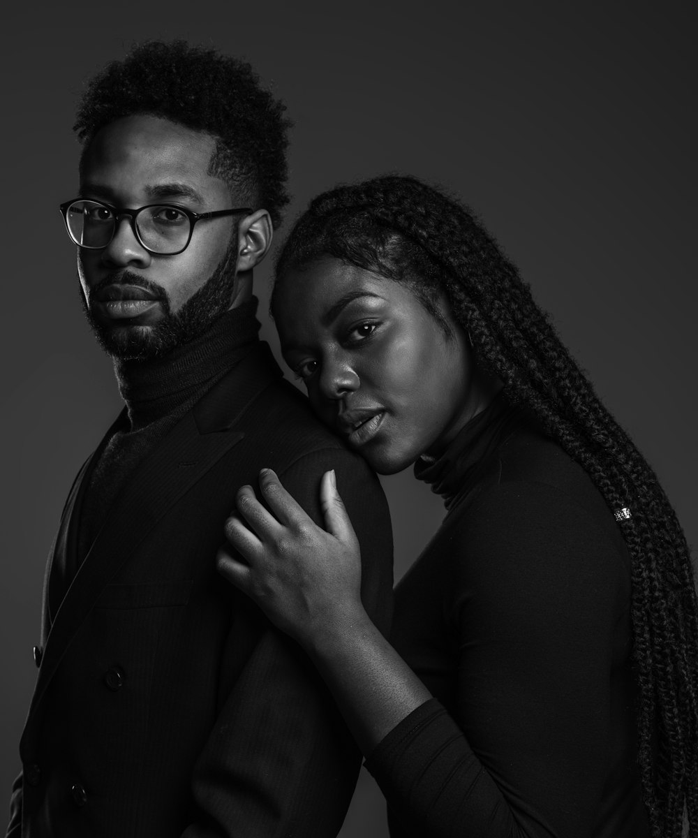 grayscale photo of man and woman posing