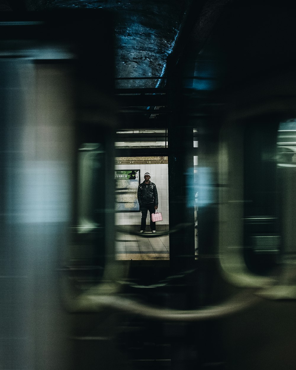 man standing near white wall