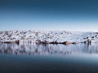 landscape photo of body of washer near mountain