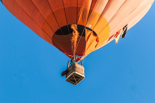 person riding a orange hot air balloon in Ponte de Sor Portugal