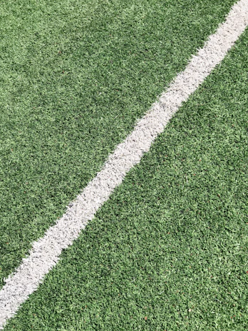 Step-by-step view showing the installation process of a stable base layer beneath artificial grass.