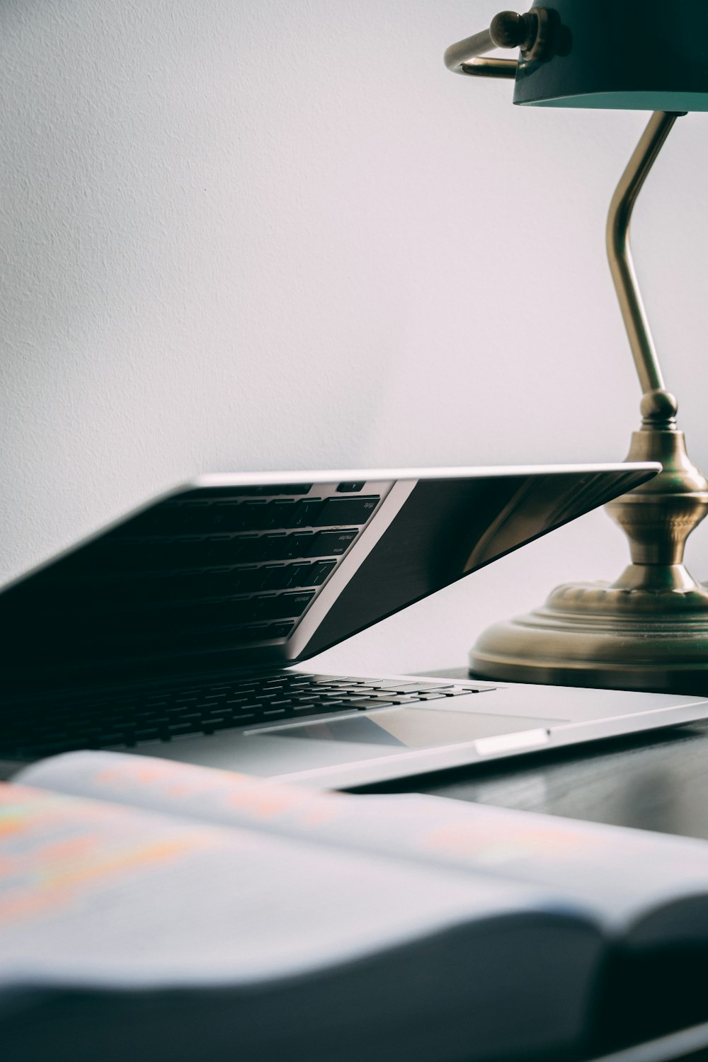 silver laptop computer near brown table lamp