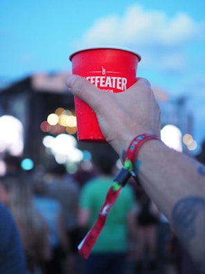 Event staff handing out drinks with beta ice tube ice at a concert