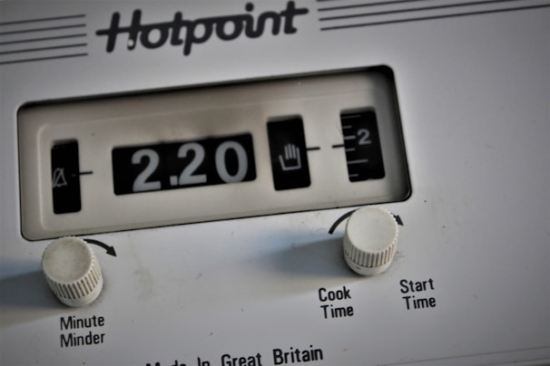 Close-up of a dryer control panel with digital timer in a cozy laundry setting