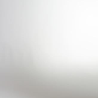 A gradient or blurred image with a smooth transition from light gray to white.