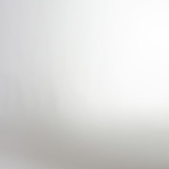 A gradient or blurred image with a smooth transition from light gray to white.