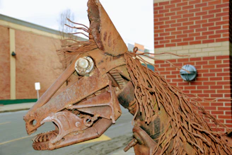 Close-up of a detailed sculpture made from rusty metal parts and discarded tools.