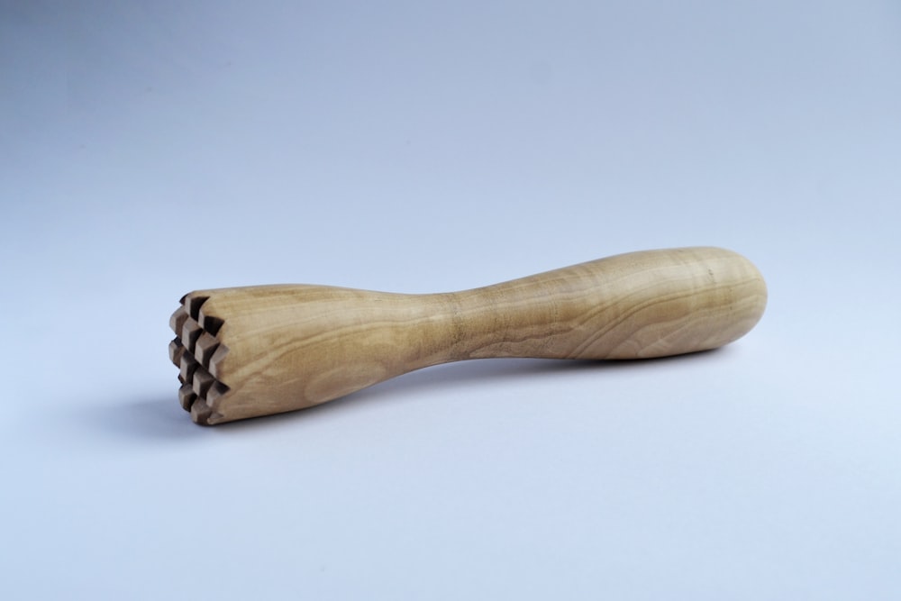 brown wooden kitchen utensil on white surface