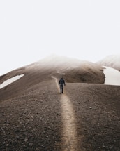 man walking on mountain