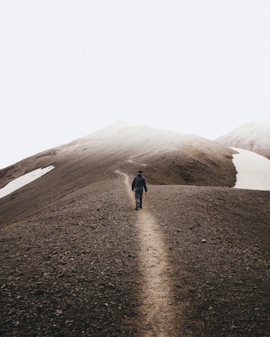 man walking on mountain in Landmannalaugar Iceland