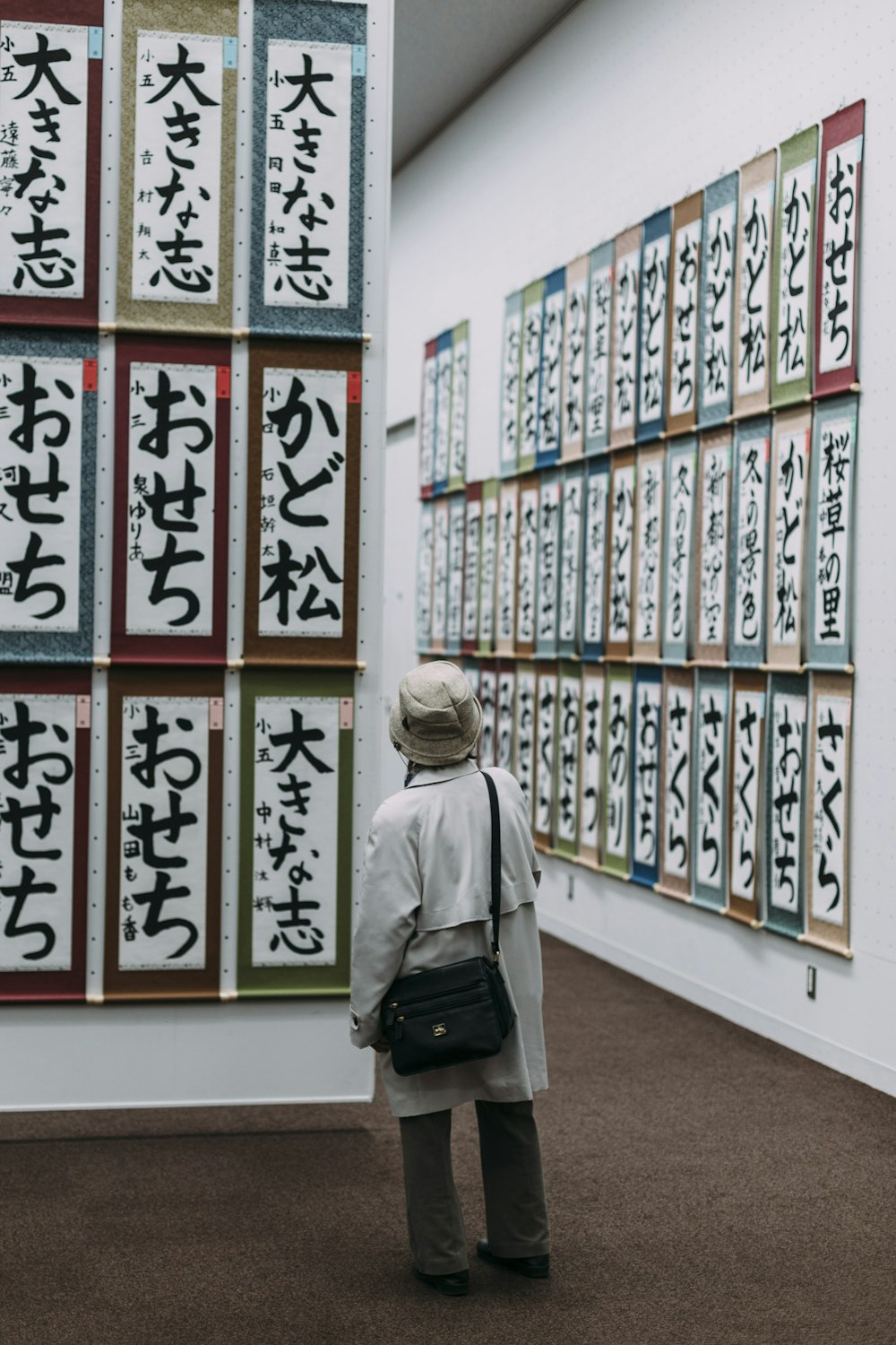 woman standing in front of scrolls