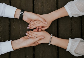 flat lay photography of man and woman holding hands together