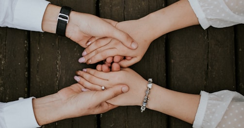 flat lay photography of two people holding hands together