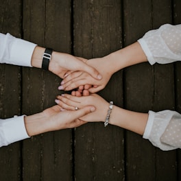 flat lay photography of two people holding hands together