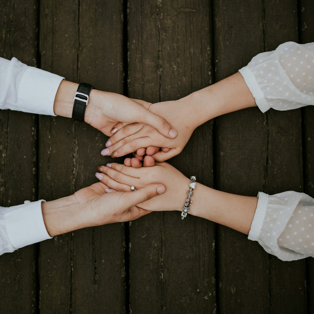 flat lay photography of man and woman holding hands together