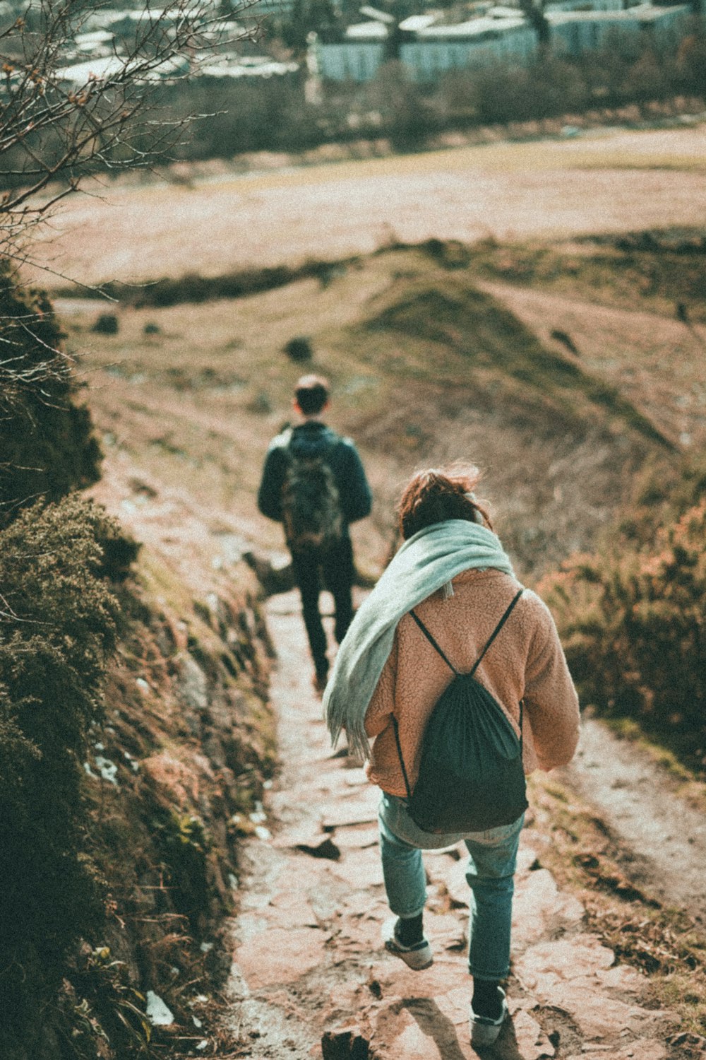 woman in blue jeans walking downhill