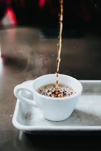 Vanilla latte as espresso pours