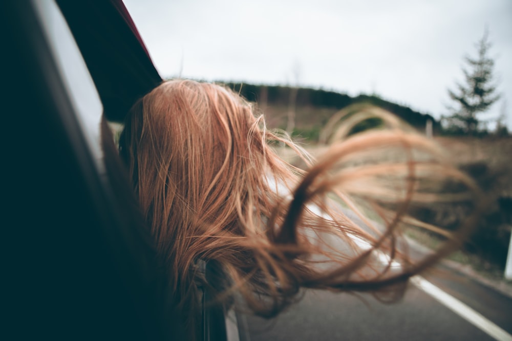 woman looking outside car window